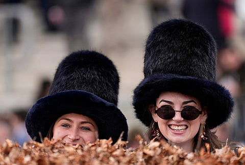Racegoers attend Ladies Day of the 2026 Cheltenham Festival at Cheltenham Racecourse, England.