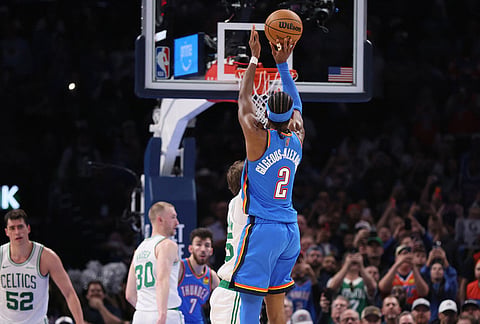 Oklahoma City Thunder guard Shai Gilgeous-Alexander (2) shoots a 2-point basket to break Wilt Chamberlain's 20-point streak record during the second half of an NBA basketball game against the Boston Celtics, in Oklahoma City. 