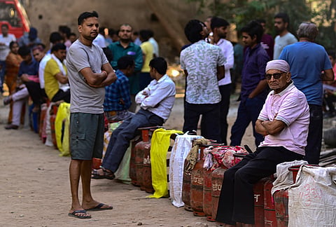 People queue up to avail LPG cylinders, amid supply crisis in the country, in Prayagraj, Uttar Pradesh.