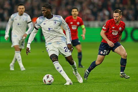 Aston Villa's Amadou Onana in action in front of Lille's Gaetan Perrin during a first leg, round of 16 Europa League soccer match between Lille and Aston Villa in Lille, France.