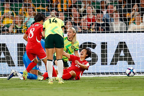 North Korea's Chae Un Yong, right, reacts after scoring her team's first goal during the Women's Asian Cup quarterfinal soccer match between Australia and North Korea in Perth, Australia.