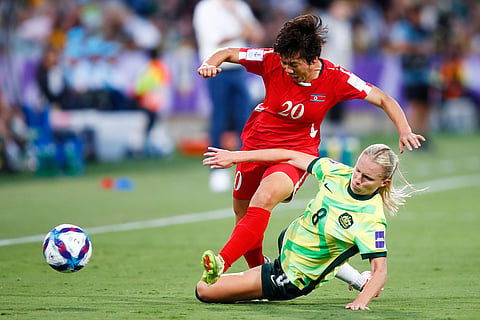 North Korea's Chae Un Yong, left, and Australia's Kaitlyn Torpey battle for the ball during the Women's Asian Cup quarterfinal soccer match between Australia and North Korea in Perth, Australia.