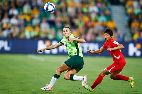 Australia's Caitlin Foord, left, and North Korea's Ri Myong gum battle for the ball during the Women's Asian Cup quarterfinal soccer match between Australia and North Korea in Perth, Australia.