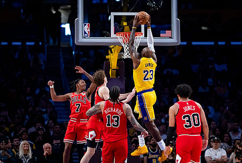 Los Angeles Lakers forward LeBron James (23) dunks the ball against the Chicago Bulls during the second half of an NBA basketball game in Los Angeles.