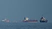 War On Iran: Closing The Strait of Hormuz Has Far-Reaching Consequences Credit: AP Photo/ Altaf Qadri | Representative Image : Oil tankers and cargo ships line up in the Strait of Hormuz as seen from Khor Fakkan, United Arab Emirates, Wednesday, March 11, 2026