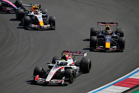 Haas driver Oliver Bearman, left, of Britain leads the pack against Red Bull driver Isack Hadjar, right, of France and Racing Bulls driver Liam Lawson of New Zealand during the Sprint Race of the Chinese Formula One Grand Prix at the Shanghai International Circuit, in Shanghai, China.