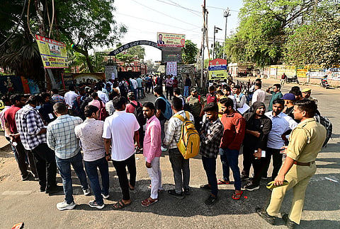 Aspirants stand in a queue before they are allowed to appear for the Sub Inspector (SI) 2026 written examination conducted by Uttar Pradesh Police Recruitment and Promotion Board (UPPRPB), in Prayagraj, Uttar Pradesh.