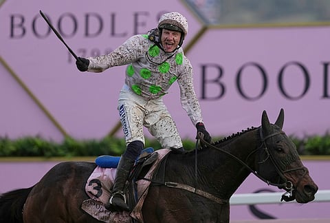 Paul Townend jockey of Gaelic Warrior the winner of the Gold Cup race, celebrates as he rides past the winning post on day four of the 2026 Cheltenham Festival in Cheltenham, England.