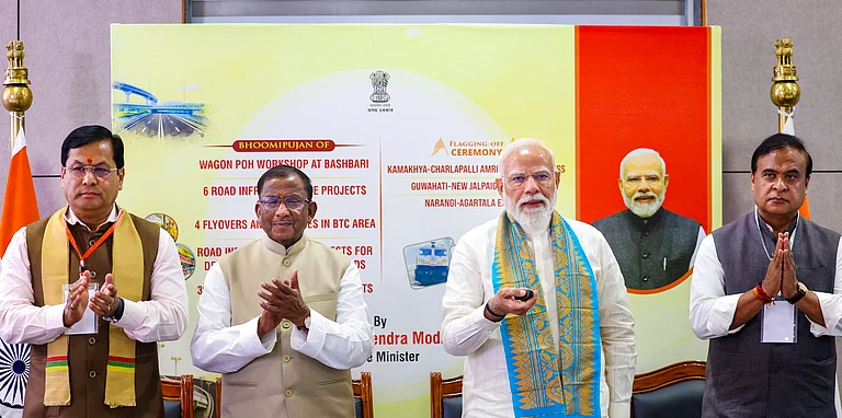 In this image received on March 13, 2026, Prime Minister Narendra Modi lays the foundation stone and unveils various development works in Kokrajhar, Assam. Union Minister Sarbananda Sonowal, state Governor Lakshman Acharya, state CM Himanta Biswa Sarma also seen. - null