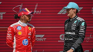AP Photo/Andy Wong : Winner Mercedes driver George Russell, right, of Britain talks with third placer Ferrari driver Lewis Hamilton of Britain after the Sprint Race of the Chinese Formula One Grand Prix at the Shanghai International Circuit, in Shanghai, China, Saturday, March 14, 2026.