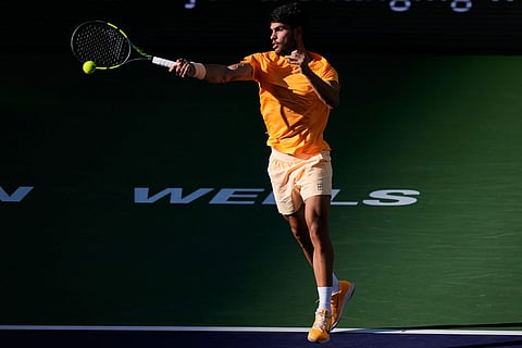 Carlos Alcaraz, of Spain, returns a shot against Daniil Medvedev, of Russia, during a semifinal match at the BNP Paribas Open tennis tournament in Indian Wells, Calif.
