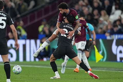 Manchester City's Matheus Nunes, front, and West Ham's Pablo vie for the ball during the English Premier League soccer match between West Ham United and Manchester City in London, England.