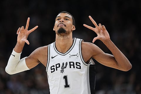 San Antonio Spurs forward Victor Wembanyama (1) celebrates a score against the Charlotte Hornets during the second half of an NBA basketball game in San Antonio.