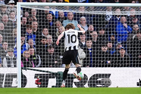 Newcastle United's Anthony Gordon scores their side's first goal of the game during the Premier League match between Chelsea and Newcastle, in London.