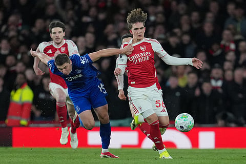 Everton's Vitaliy Mykolenko pulls Arsenal's Max Dowman during the English Premier League soccer match between Arsenal and Everton in London, England.
