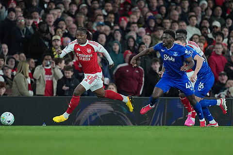 Arsenal's Eberechi Eze, left, and Everton's Tim Iroegbunam run for the ball during the English Premier League soccer match between Arsenal and Everton in London, England.