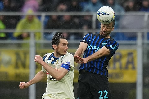 Atalanta's Marten de Roon, left, and Inter Milan's Henrikh Mkhitaryan fight for the ballduring the Serie A soccer match between Inter Milan and Atalanta in Milan, Italy.