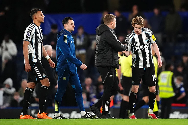 Newcastle United's Anthony Gordon, right, is congratulated by manager Eddie Howe following victory in the Premier League match between Chelsea and Newcastle, in London. - | Photo: John Walton/PA via AP