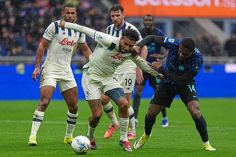 Atalanta's Ederson, left, and Inter Milan's Ange-Yoan Bonny fight for the ball during the Serie A soccer match between Inter Milan and Atalanta in Milan, Italy.