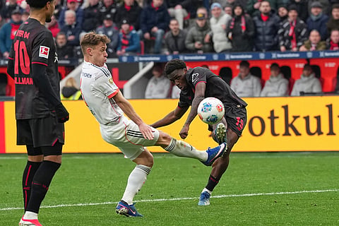 Leverkusen's Ernest Poku, right, makes an attempt to score during a German Bundesliga soccer match between Bayer Leverkusen and Bayern Munich in Leverkusen, Germany.