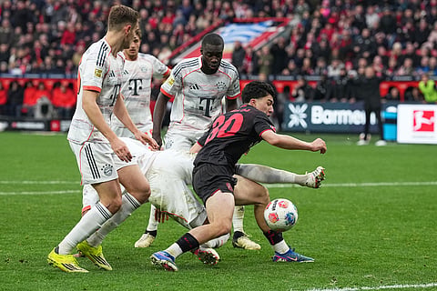 Leverkusen's Ibrahim Maza, centre, in action during a German Bundesliga soccer match between Bayer Leverkusen and Bayern Munich in Leverkusen, Germany.