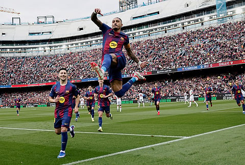 Barcelona's Raphinha celebrates after scoring his side's opening goal during the Spanish La Liga soccer match between Barcelona and Sevilla in Barcelona, Spain.