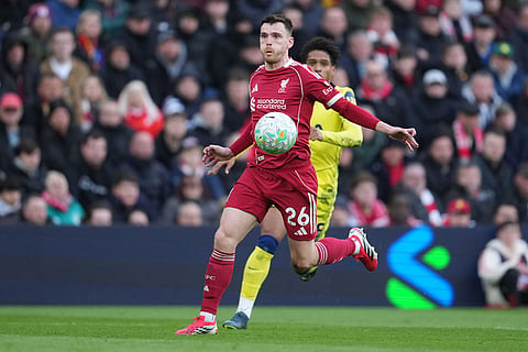 Liverpool's Andrew Robertson controlls the ball during the Premier League soccer match between Liverpool and Tottenham in Liverpool, England.