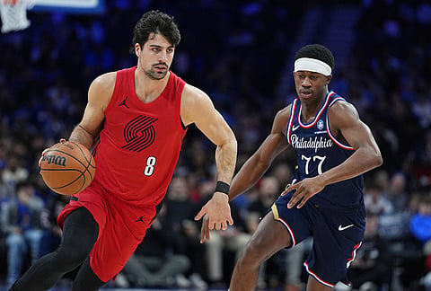 Portland Trail Blazers' Deni Avdija (8) drives past Philadelphia 76ers' Vj Edgecombe during the first half of an NBA basketball game, in Philadelphia.