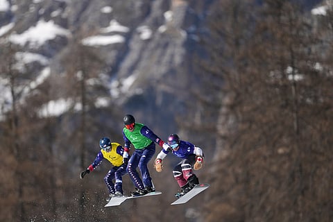 Zach Miller, of the United States, from left, Keith Gabel, of the United States, and Alex Massie, of Canada, compete in a men's snowboard cross SB-LL2 semifinal at the 2026 Winter Paralympics, in Cortina d'Ampezzo, Italy.