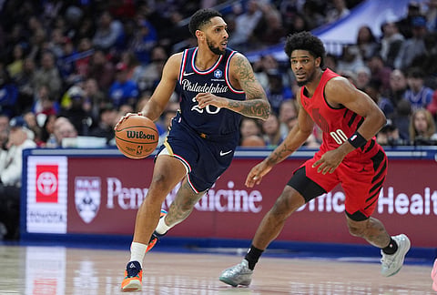Philadelphia 76ers' Cameron Payne, left, drives past Portland Trail Blazers' Scoot Henderson during the second half of an NBA basketball game in Philadelphia.