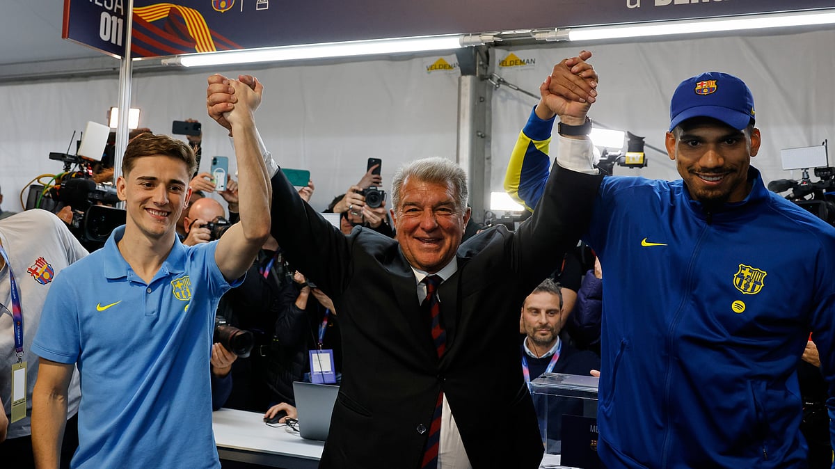 Joan Laporta, center, reacts as he poses with players Gavi, left, and Ronald Araujo after the voting for the election to be president of FC Barcelona in Barcelona, Spain, Sunday, March 15, 2026.  -  (AP Photo/Joan Monfort)