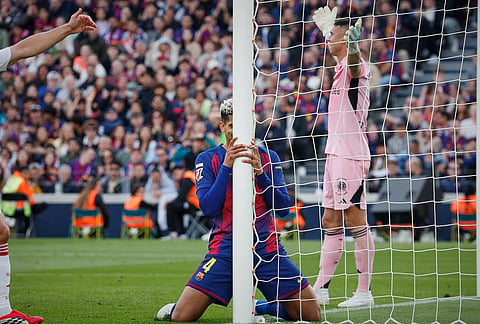 Barcelona's Ronald Araujo reacts after missing a scoring chance during the Spanish La Liga soccer match between Barcelona and Sevilla in Barcelona, Spain.