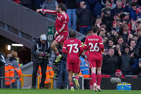 Liverpool's Dominik Szoboszlai celebrates after scoring during the Premier League soccer match between Liverpool and Tottenham in Liverpool, England.
