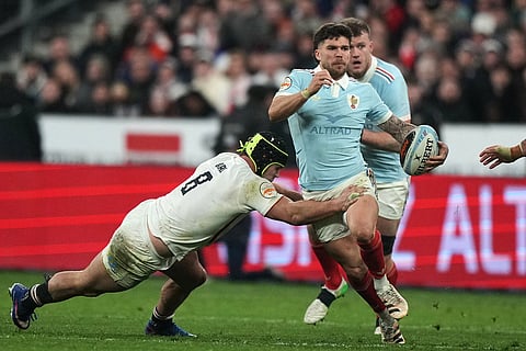 England's Ben Earl tackles Matthieu Jalibert of France during the Six Nations rugby union match between France and England in Saint-Denis, outside Paris.