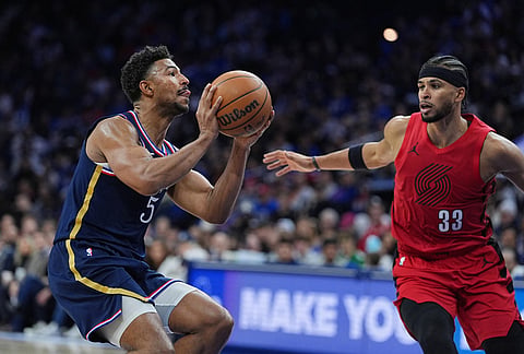 Philadelphia 76ers' Quentin Grimes (5) goes up to shoot against Portland Trail Blazers' Toumani Camara during the second half of an NBA basketball game, in Philadelphia.