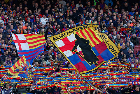 Fans of Barcelona's team cheer during the Spanish La Liga soccer match between Barcelona and Sevilla in Barcelona, Spain.