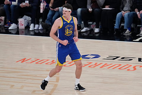 Golden State Warriors' Quinten Post reacts after a basket during the first half of an NBA basketball game against the New York Knicks in New York. 