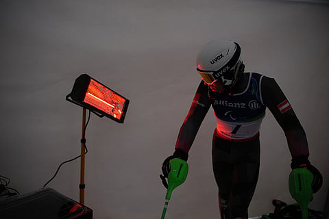 Johannes Aigner, of Austria, waits his turn to start his first run of the alpine skiing men's slalom vision impaired at the 2026 Winter Paralympics, in Cortina d'Ampezzo, Italy.