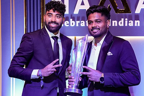 Indian men's cricket team player Mohammed Siraj, left, and Sanju Samson with a trophy during the BCCI Naman Awards 2026, in New Delhi.