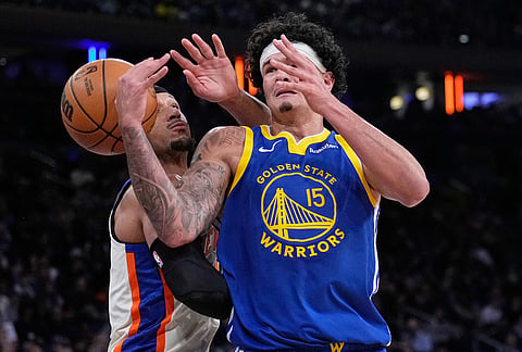 New York Knicks' Josh Hart, left, and Golden State Warriors' Gui Santos fight for a rebound during the first half of an NBA basketball game in New York.