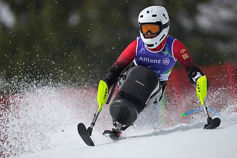 Zhang Wenjing, of China, competes in her first run of the alpine skiing women's giant slalom sitting at the 2026 Winter Paralympics, in Cortina d'Ampezzo, Italy.