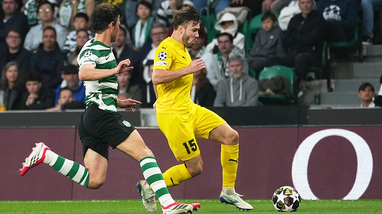 Glimt's Fredrik Andre Bjorkan, right, is challenged by Sporting's Eduardo Quaresma during a Champions League round of 16 second leg. - AP/Ana Brigida