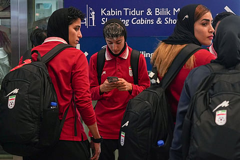 Members of Iran's women's football team arrive at the Kuala Lumpur International Airport in Sepang, Malaysia.