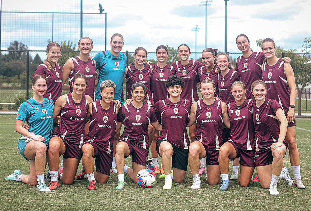 | Photo: Brisbane Roar via AP : Iranian soccer player's Fatemeh Pasandideh, fourth from right at front row, and Atefeh Ramezanisadeh, fourth from left at front row, pose for a photo with the Brisbane Roar women's A-League team at a training session in Brisbane, Australia.