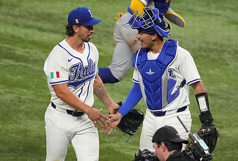 Italy pitcher Michael Lorenzen and catcher JJ D'Orazio shake hands during the fifth inning of a World Baseball Classic semifinal game against Venezuela, in Miami.