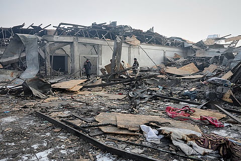 Residents and rescue workers inspect the site of a late-Monday airstrike at a drug rehabilitation hospital in Kabul, Afghanistan.