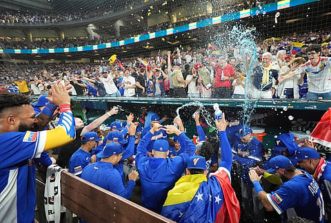 The Venezuela team celebrates after defeating Italy at a World Baseball Classic semifinal game in Miami. 