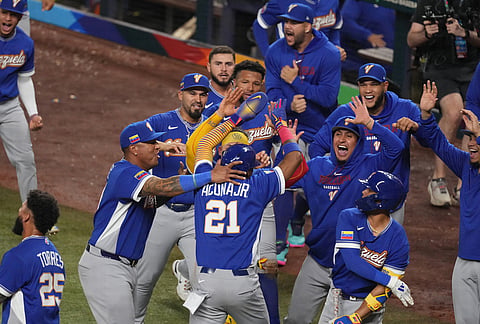 Venezuela Ronald Acuña Jr. (21) celebrates after scoring during the seventh inning of a World Baseball Classic semifinal game against Italy, in Miami. 