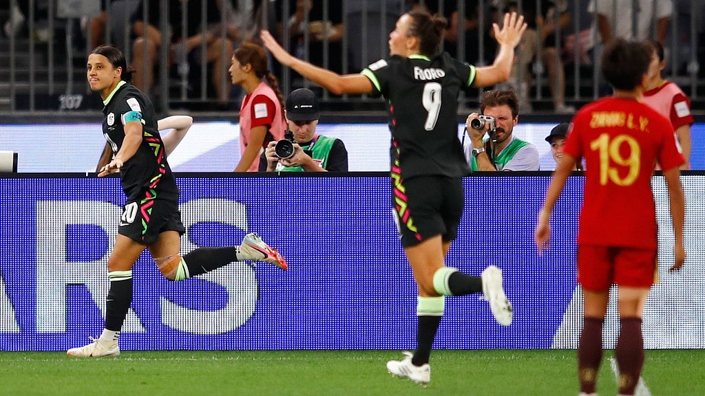 Photo: AP : Australia's Sam Kerr, left, reacts after scoring her team's second goal during the Women's Asian Cup semi-final between China and Australia in Perth.