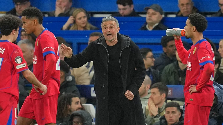 PSG's head coach Luis Enrique talks to his players during the Champions League soccer match. - AP